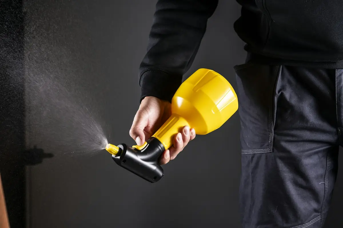 Pest control technician holding a pressure sprayer